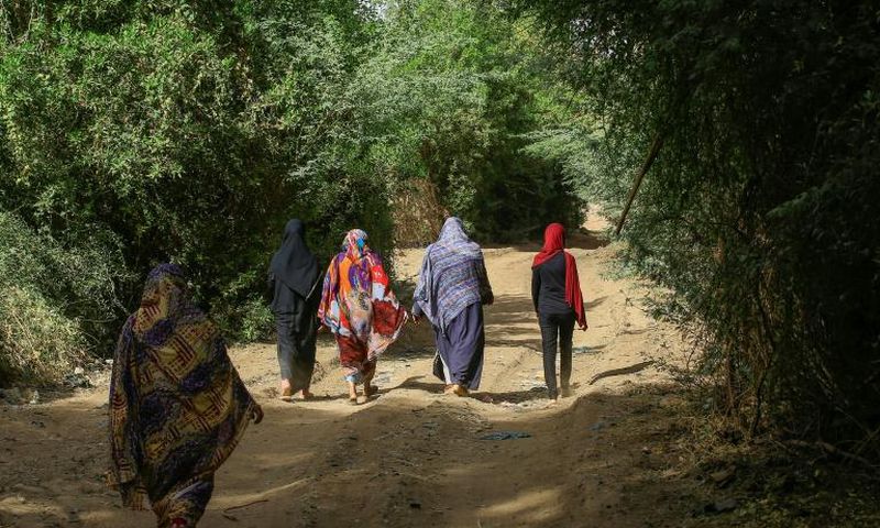 Sudanese women walk in the capital Khartoum's district of Jureif Ghar