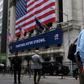 The New York Stock Exchange, the symbolic heart of Wall Street, reopened its floor after a two-month closure due to the coronavirus, with traders donning masks and separated by plexiglas