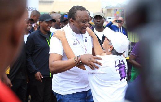 First Lady Margaret Kenyatta receives President Uhuru Kenyatta after competing in the Beyond Zero Half Marathon