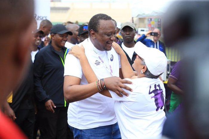 First Lady Margaret Kenyatta receives President Uhuru Kenyatta after competing in the Beyond Zero Half Marathon