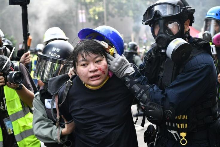 Protesters are detained by police near the Hong Kong Polytechnic University in November 2019