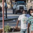 Two men wear masks as they walk in the streets of downtown Port-au-Prince on March 26, 2020. When the novel coronavirus first appeared  in Haiti authorities and humanitarian experts panicked, worried about the country's decrepit health system -- but he...