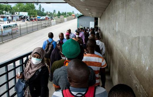 People walk on a pedestrian bridge without adhering to social distancing in Dar es Salaam, Tanzania, in April 2020
