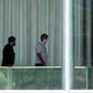 Brazilian President Jair Bolsonaro (R) walks with a consultant inside the Palacio Alvorada, in Brasilia, on March 13, 2020, after testing negative for the new coronavirus