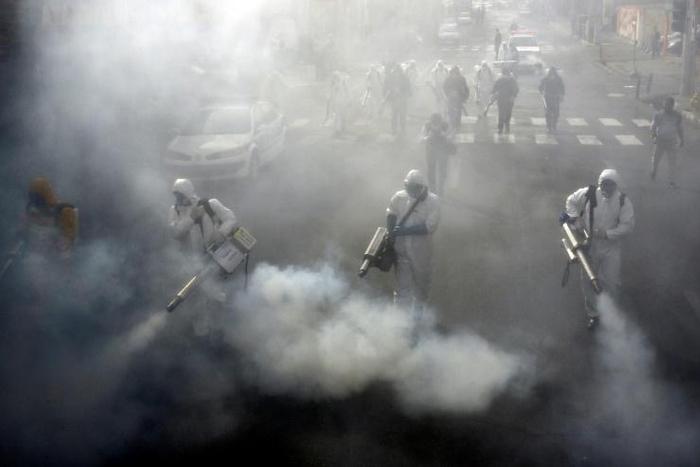 Firefighters disinfect streets in the Iranian capital Tehran in a bid to stem the spread of the coronavirus