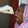A woman is tested for coronavirus in New Delhi. Cases are soaring in the world's second most populous nation