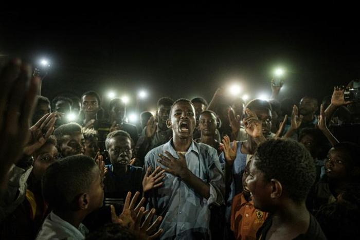 The AFP photo of Mohamed Youssef reciting a poem at a Khartoum demonstration on June 19, 2019, became an iconic image of the Sudanese revolution