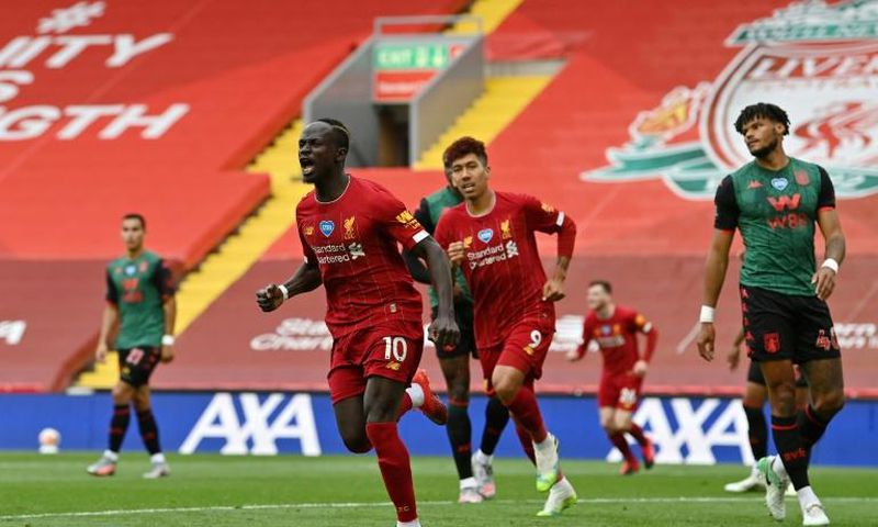 Sadio Mane (centre) celebrates his 20th goal of the season for Liverpool