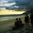 People wear face masks as they walk along Ipanema Beach in Rio de Janeiro on May 19, 2020. The peak of Brazil's outbreak is not expected until June