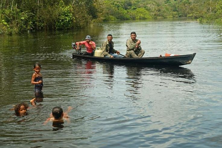Fishermen and children are seen in the river in Bauana, a village in the heart of the Brazilian Amazon, on March 14