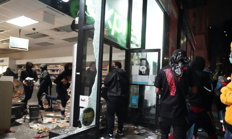 Looters hit stores in New York where the mayor has imposed an overnight curfew