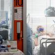 Medical workers wearing a face make and protection gear tend to a patient inside the new coronavirus intensive care unit of the Brescia Poliambulanza hospital as the town saw the country's highest daily rise in case numbers