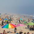 People enjoy the sun and sand amid the novel coronavirus pandemic in Huntington Beach, California