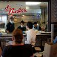 Staff at The Original Ninfa's restaurant in Houston, Texas, seen wearing gloves and masks, on May 1, 2020