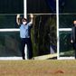 Brazilian President Jair Bolsonaro waves outside Alvorada Palace in Brasilia on July 9, 2020