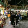 Shoppers clad in protective gear, including face masks and latex gloves, walk through Tajrish Bazaar in Iran's capital Tehran at the start of the Muslim holy month of Ramadan