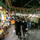 Shoppers clad in protective gear, including face masks and latex gloves, walk through Tajrish Bazaar in Iran's capital Tehran at the start of the Muslim holy month of Ramadan