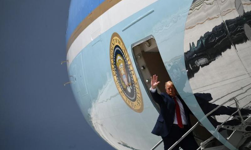 President Donald Trump waves from Air Force One in Miami on July 10, 2020