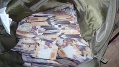 File image of money in a bag confiscated by police as evidence