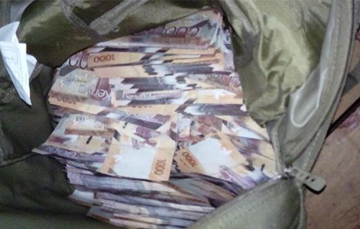 File image of money in a bag confiscated by police as evidence