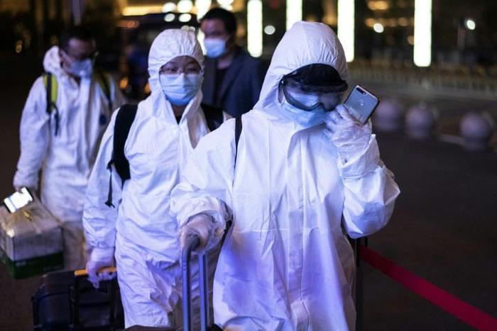 Many passengers wore hazmat suits as they arrived at Wuhan's Wuchang rail station to board some of the first trains to leave the Chinese city in more than two months