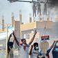 Sudanese protesters hang up effigies depicting Rapid Support Forces soldiers on the first anniversary of a deadly raid on an anti-government sit-in protest