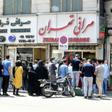 Iranians queue outside a money exchange office in the capital Tehran on Saturday