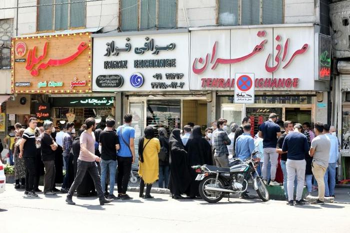 Iranians queue outside a money exchange office in the capital Tehran on Saturday