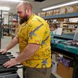 A worker moves finished AR-15 rifle barrels for storage at Delta Team Tactical in Orem, Utah