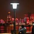 People wearing facemasks walk near the Yangtze River in Wuhan, epicentre of the coronavirus, which reported no new deaths from the disease for the first time since January