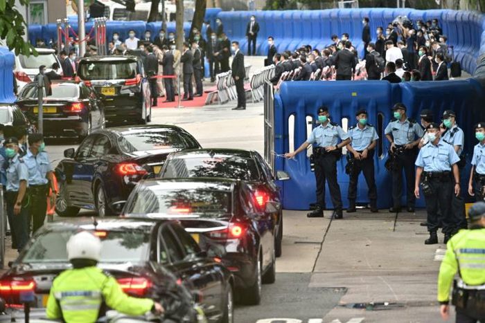 Guests drive past barriers near the Office for Safeguarding National Security of the Central People's Government in the Hong Kong Special Administrative Region after its official inauguration
