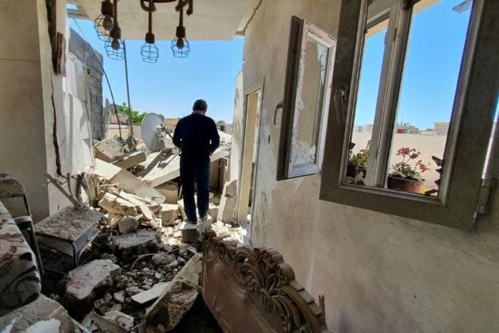 A resident walks through a building damaged by fighting in the Libyan capital Tripoli, on May 1, 2020