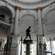 A sweeper cleans the floor of the General Post Office in Kolkata after some lockdown restrictions were relaxed