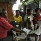 Visitors to a state hospital in Lagos collect facemasks and gloves and have their hands sanitised