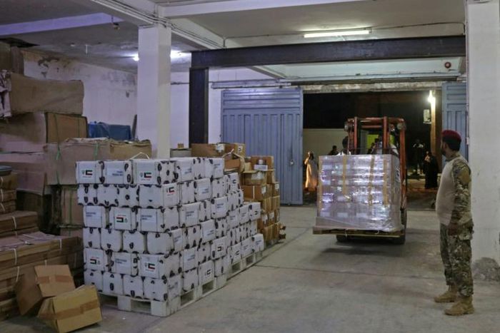 Yemeni men unload medical aid at a hospital warehouse in the war-torn country's second city of Aden, in early May
