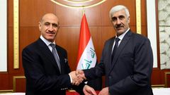 Former Iraqi football star Adnan Dirjal (L) takes the reins as sports minister from his less well-known predecessor Ahmed Ryad