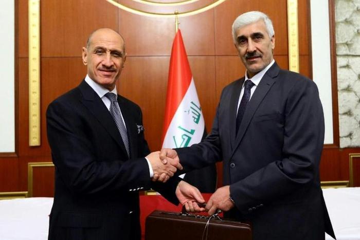 Former Iraqi football star Adnan Dirjal (L) takes the reins as sports minister from his less well-known predecessor Ahmed Ryad