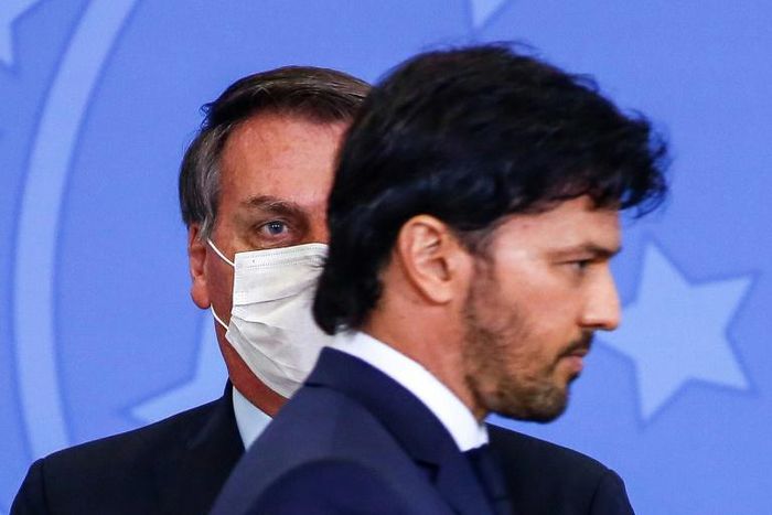 (FILES) In this file photo taken on June 17, 2020 Brazilian President Jair Bolsonaro (L) looks at his newly appointed communications minister, Fabio Faria, at the presidential office in Brasilia.Bolsonaro, backed by his new communications ministry, is ...