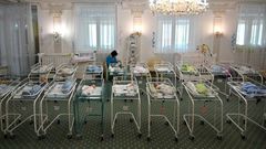 A nurse cares for newborn babies at Kiev's Venice hotel -- dozens born to surrogate mothers were stranded in Ukraine as their foreign parents were unable to collect them for weeks owing to coronavirus border closures