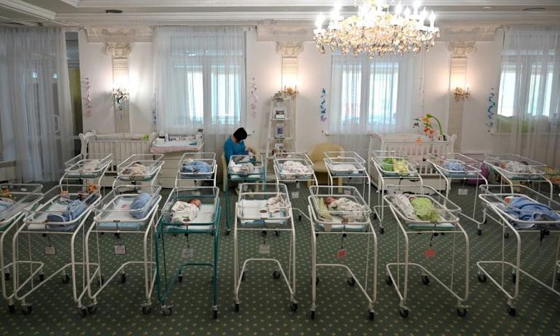 A nurse cares for newborn babies at Kiev's Venice hotel -- dozens born to surrogate mothers were stranded in Ukraine as their foreign parents were unable to collect them for weeks owing to coronavirus border closures
