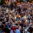 Protestors in Washington hold up their phones at a march on June 3