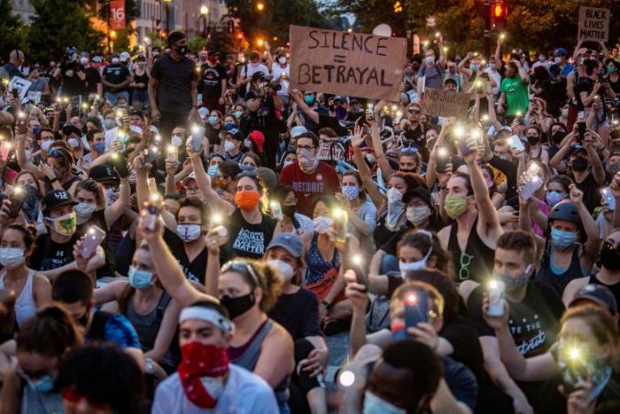 Protestors in Washington hold up their phones at a march on June 3