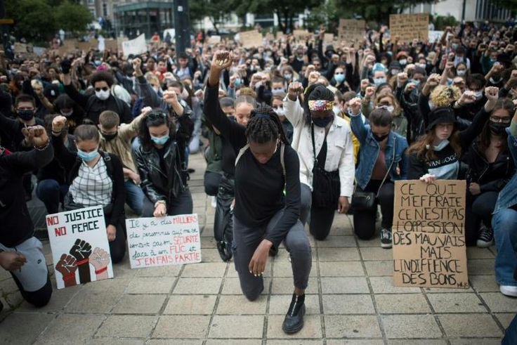 Demonstrators dropped to their knees and raised a fist as they turned out to march in the western city of Nantes