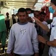 Anne (R) , a medic of French NGO SOS Mediterranee takes the temperature of migrants rescued by members of the boat Ocean Viking, off the coast of Italy's Lampedusa island