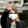 Bolivian interim President Jeanine Anez waves, while wearing a face mask, after attending a Corpus Christi procession at the Plaza de Armas in front of the government palace in La Paz, on June 11, 2020, amid the COVID-19 coronavirus pandemic