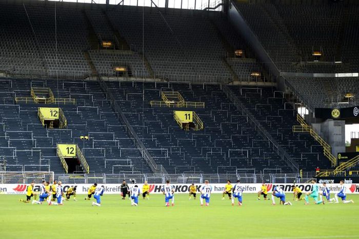 Borussia Dortmund and Hertha berlin players take a knee in solidarity with protests raging across the United States over the death of George Floyd