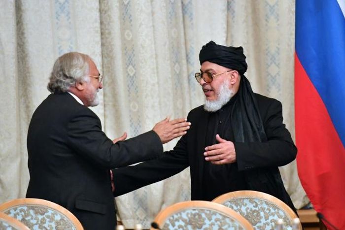 Taliban spokesman Mohammad Abbas Stanikzai (right) greets a participant during the opening of talks with Afghanistan's opposition in Moscow in February 2019