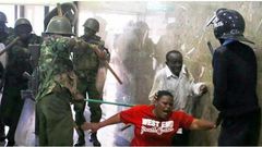 Police whipping Kenyans who were caught up in the night of terror