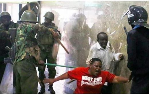 Police whipping Kenyans who were caught up in the night of terror