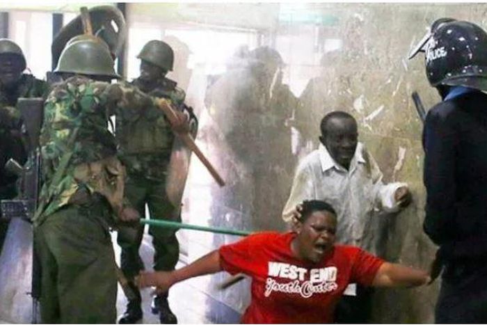 Police whipping Kenyans who were caught up in the night of terror